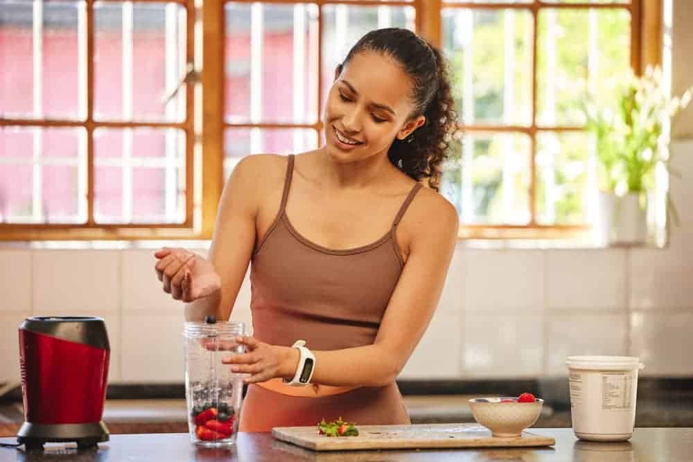 Woman Making Smoothie with a Portable Blender